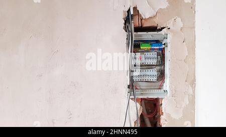 Electrical safety in homes, switchboard panel with switches. Home electrical system in the apartment under repair. Circuit breakers with wires in an electric screen with copy space. Stock Photo