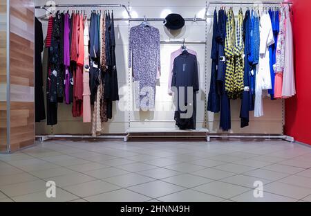 Fashion show of stylish stylish luxurious clothes inside the store on hangers. Editorial photo. Shopping is a favorite vacation for girls and women. Stock Photo