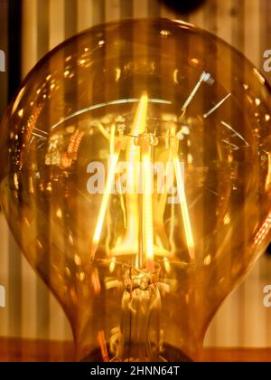 Close up view of vintage light bulbs with warm yellow light. Stock Photo