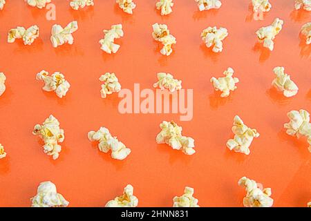 Fresh popcorn isolated on orange background, top view. Popcorn on a colored background. Minimal food concept. Entertainment, film and video content. A Stock Photo