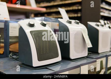 Electric fan heaters on construction supply store shelf. Stock Photo