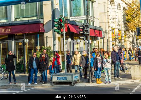 people wait at a red traffic light for go sign at the famous street unter den Linden in Berlin, Germany Stock Photo