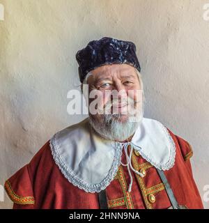 old man dressed in medieval clothes in Rothenburg Stock Photo