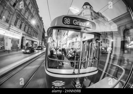 Old fashioned tram by a night ride in Vienna, Austria. Vienna has an extensive train and bus network Stock Photo