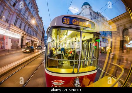 Old fashioned tram by a night ride in Vienna, Austria. Vienna has an extensive train and bus network Stock Photo