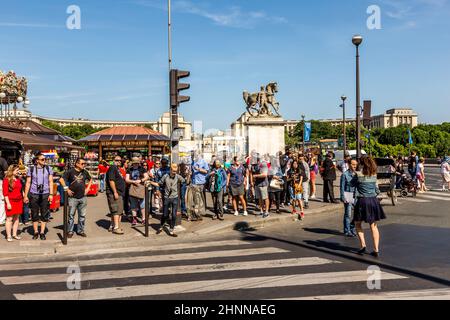 people visit the landmarks of Paris and wait for green light to cross the street Stock Photo