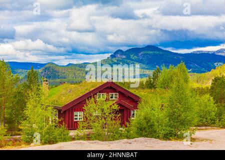 Norwegian wooden cabins cottages in the nature and mountain landscape of Treungen in Nissedal Norway. Stock Photo