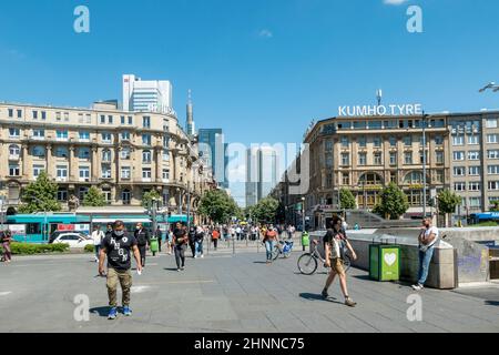 people at the square in front of the central station with view to skyscraper. Stock Photo