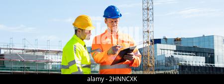 Construct Site Engineer Pointing. Worker Inspector With Clipboard Stock Photo