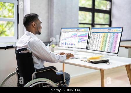 Medical Coding Spreadsheet On PC. African Man In Wheelchair Stock Photo