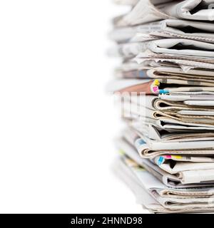 Pile of stacked generic folded newspapers background on white background with copy space. News and updates concept. Stock Photo