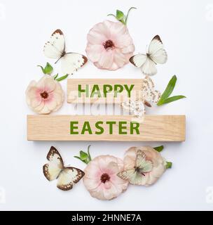 Easter Flat Lay background of Eggs, spring flowers and  Happy Easter inscription Stock Photo