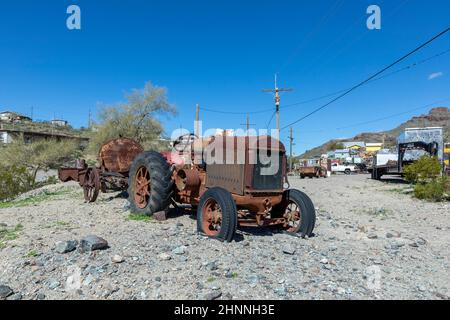 old rotten rusty tractor from former times at Route 66  in the village of Oatman. Stock Photo