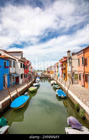 colorful houses at the island of Burano along the canal in lagoon of Venice, Italy Stock Photo