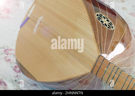 a musician is holding a saz, turkish musical instruments, close-up baglama, Stock Photo