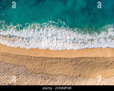 Top down aerial view of a clean sand beach on the shores of a beautiful turquoise Liguria sea, Italy Stock Photo
