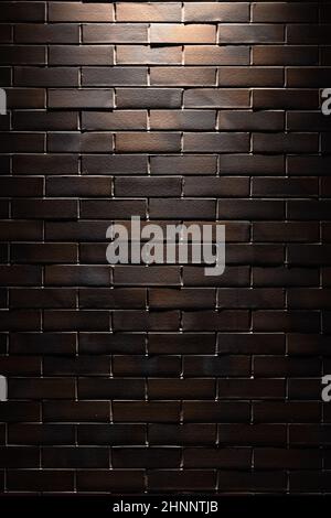Brick Wall Texture. One spotlight at brick wall texture or background photo. Advertising or product vertical background photo. Stock Photo