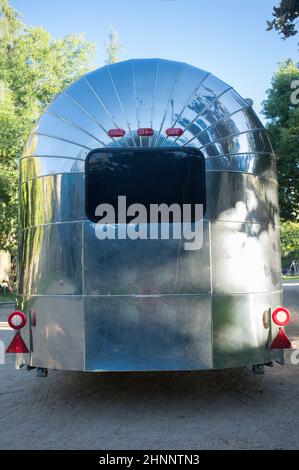 Rounded metal american caravan used as mobile catering vehicle. Rear view Stock Photo