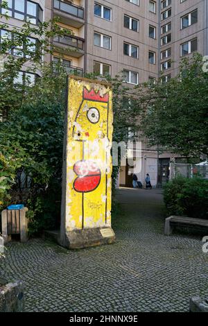Original part of the Berlin Wall as decoration on a backyard in Berlin Stock Photo