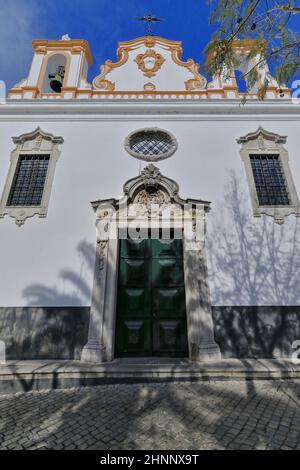 Whitewashed facade-Baroque pediment-Rococo doorcasing-St.Joseph of the Hospital-Holy Spirit Church. Tavira-Portugal-119 Stock Photo