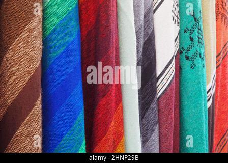 Colourful textile scarfs or blankets displayed on street market in Fes, Morocco - closeup detail Stock Photo