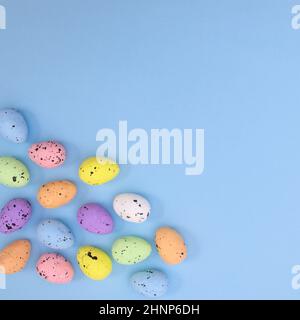 Rainbow colorful eggs for Easter on pastel blue background. Flat lay concept minimal Stock Photo