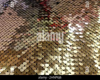 Close up view on samples of sequin fabric in golden colors Stock Photo