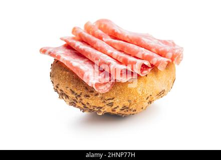 Bun with sliced salami isolated on a white background. Stock Photo