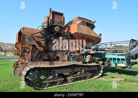 Old rusty disassembled combine harvester. Stock Photo