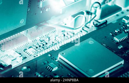 Electronic circuit board. Mainboard of computer. Computer integrated circuit board. Detail of electronic circuit board. Memory of digital information hardware. Electronic engineering technology. Stock Photo