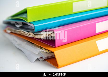 File Folder Binder stack of multi color on table in business office. Stock Photo