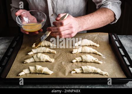 Baking sheet of raw homemade croissants stuffed with chocolate spread Stock Photo