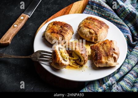 Bacon-wrapped button mushrooms stuffed with grated cheddar cheese and spices Stock Photo