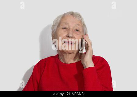 senior woman talking on phone indoor Stock Photo