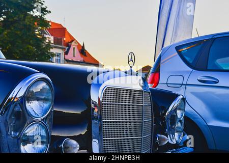 Mercedes Benz logo on a black vintage car. Mercedes-Benz is a German automobile producer. The brand is used for luxury automobiles, buses, coaches and trucks. Stock Photo