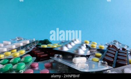 Pills, capsules with medicine, vitamins in the package, in blister packs are on the table. antibiotics, multicolor antibacterial drugs. Healthcare and medicine concept. Copy space. Stock Photo