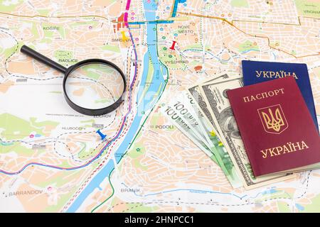 Travel arrangement with dollars, euro, two passports and magnifying glass on a map background. Travel concept. Stock Photo