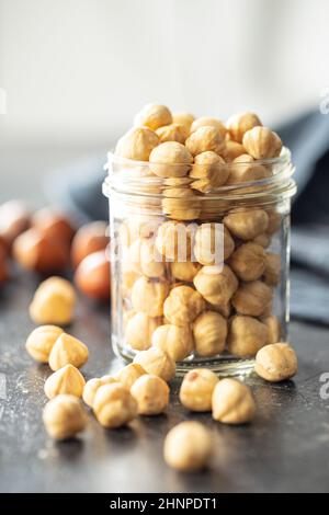 Peeled roasted hazelnut kernels in jar. Stock Photo