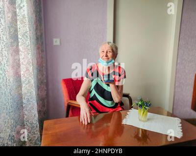 Happy 70s grandmother hold smartphone record audio message talking on gadget at home Stock Photo