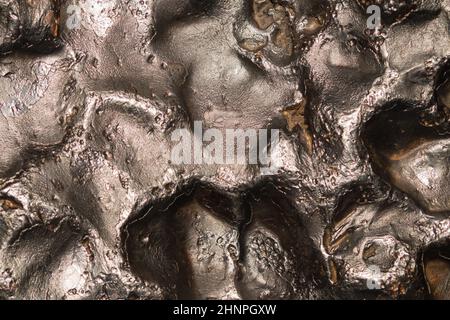 Meteorite texture background. meteorite surface close up. stone backdrop Stock Photo