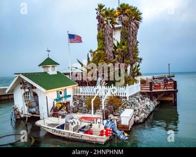 tourists visit Forbes Island, now closed. It was a restaurant between Pier 39 and Pier 41 in Fisherman's Wharf, San Francisco Stock Photo