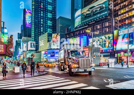 NEW YORK, USA  OCT 7, 2017:  neon advertising of News, brands and theaters at times square in late afternoon. Times square is a symbol for New York life and amusement. Stock Photo