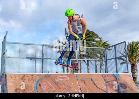 boy jumping at the skate park over a ramp Stock Photo