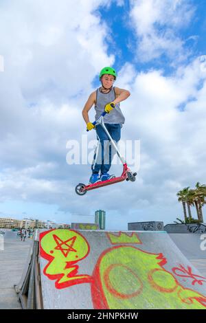 boy jumping at the skate park over a ramp Stock Photo