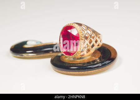 Golden ring with the ruby isolated on white. jewelry background Stock Photo