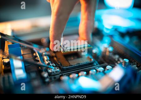 Motherboard Microchip In Hand. Computer Testing And Repair Stock Photo