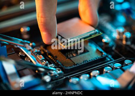 Motherboard Microchip In Hand. Computer Testing And Repair Stock Photo