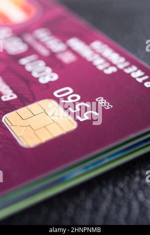 Stack of credit cards with details of a card with its chip and some numbers Stock Photo