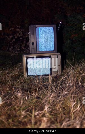 TV no signal in grass t night Stock Photo