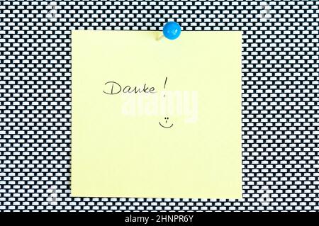 Postit note saying Danke arranged on black and white background Stock Photo